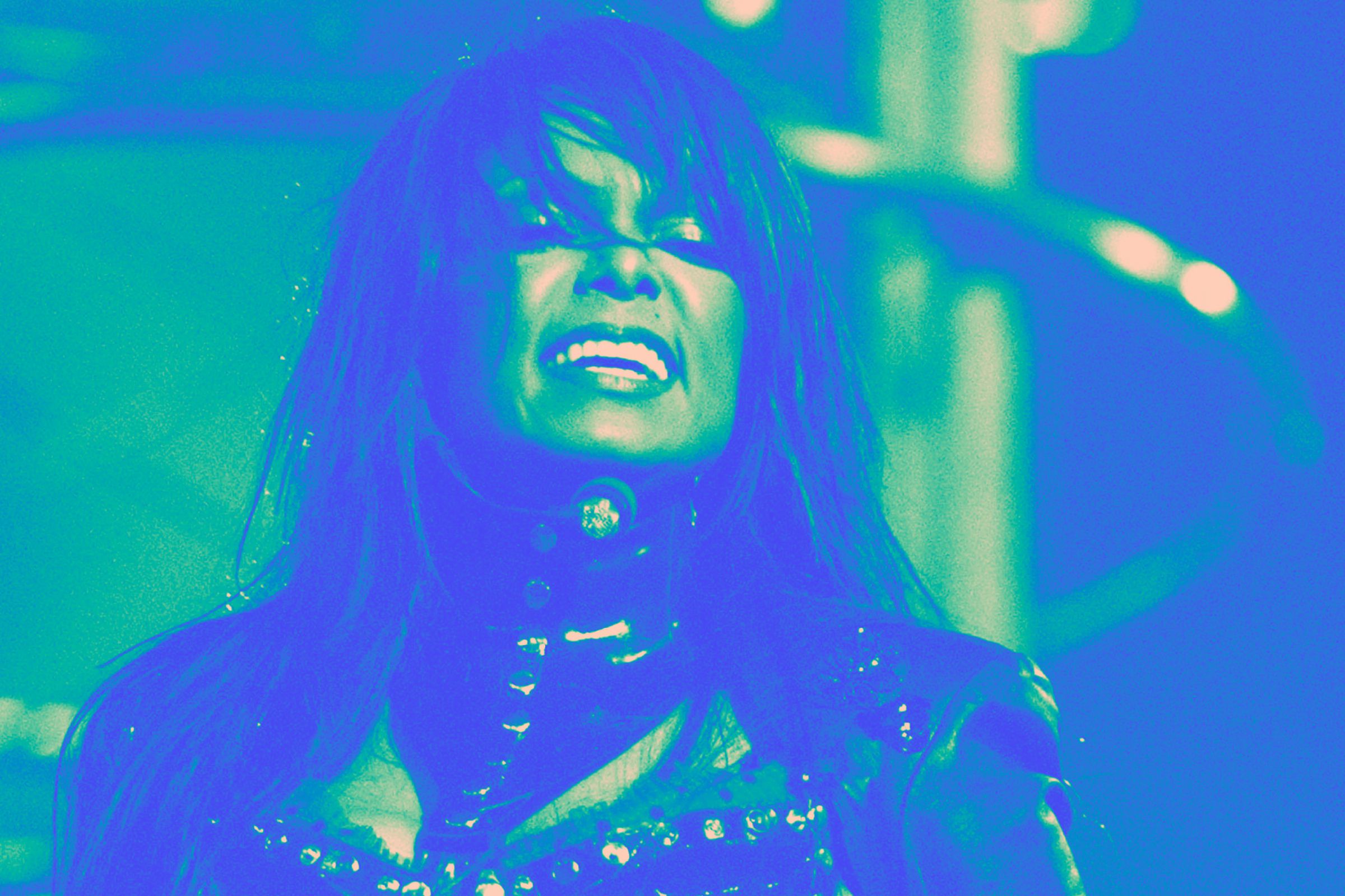 Photo of Janet Jackson with a green and blue filter over it.