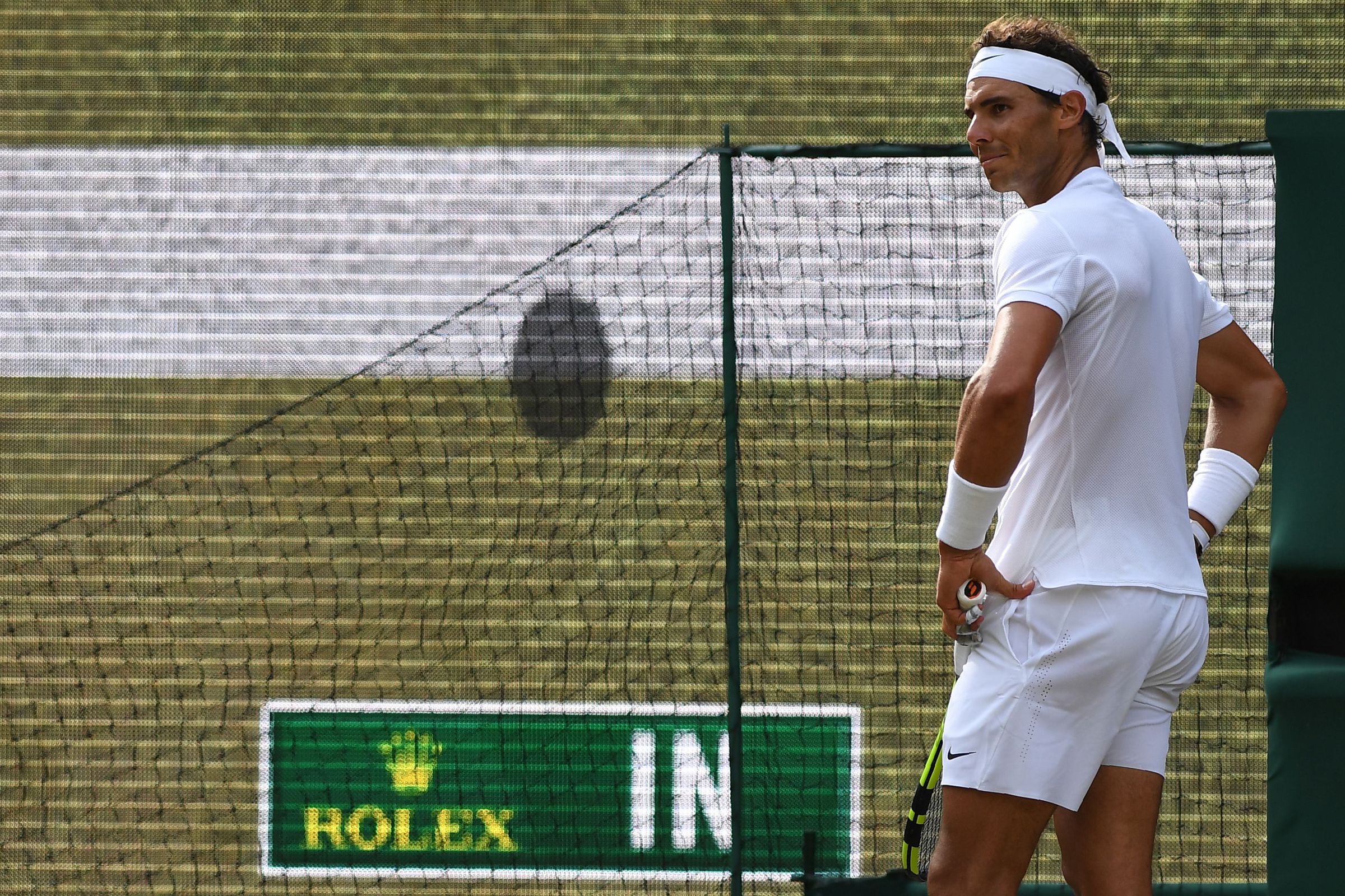 Spain’s Rafael Nadal reacts as the scoreboard shows the result of a hawk-eye challenge during a point against Russia’s Karen Khachanov during their men’s singles third round match on the fifth day of the 2017 Wimbledon Championships at The All England Lawn Tennis Club in Wimbledon, southwest London, on July 7, 2017