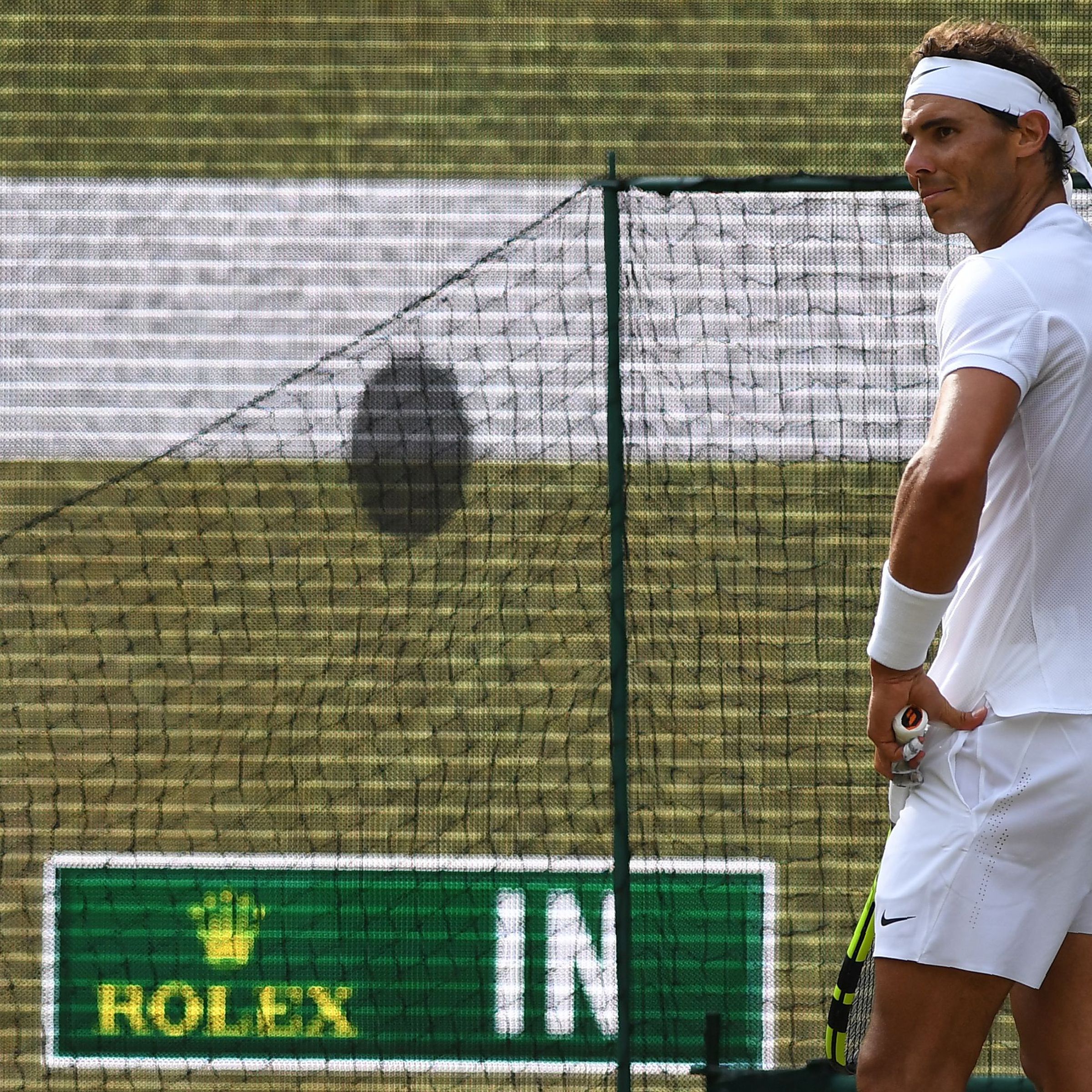 Spain’s Rafael Nadal reacts as the scoreboard shows the result of a hawk-eye challenge during a point against Russia’s Karen Khachanov during their men’s singles third round match on the fifth day of the 2017 Wimbledon Championships at The All England Lawn Tennis Club in Wimbledon, southwest London, on July 7, 2017
