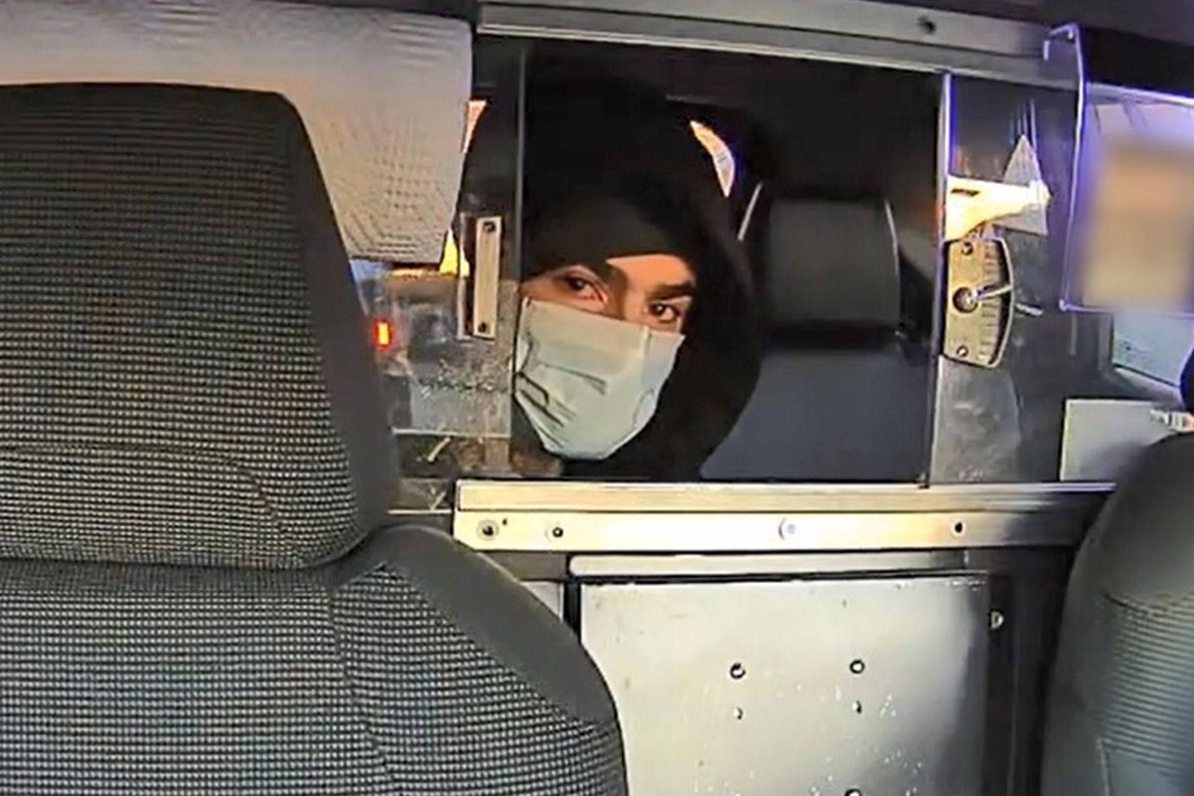 A NYPD photo of the person of interest in the case. The person is in a taxi.