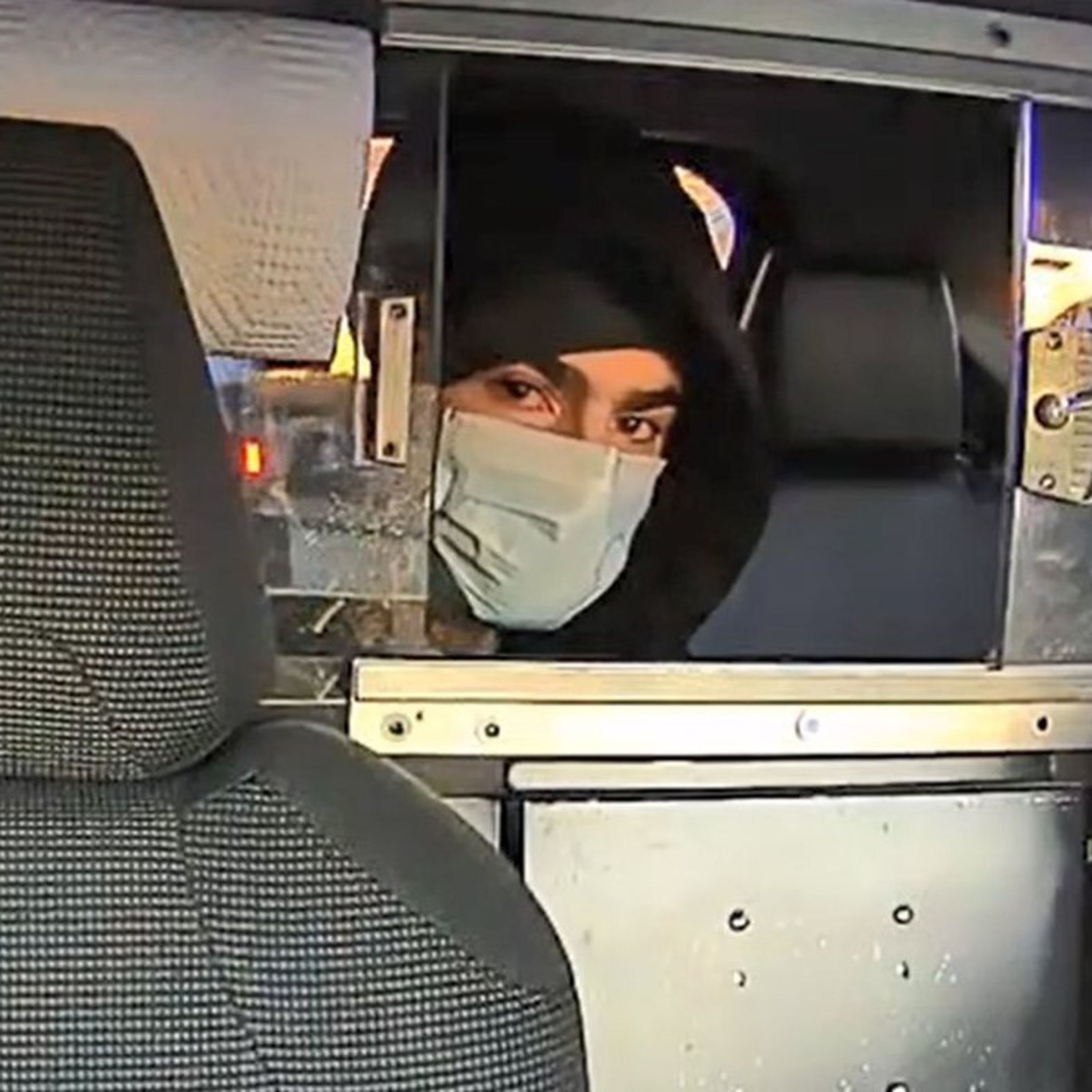 A NYPD photo of the person of interest in the case. The person is in a taxi.