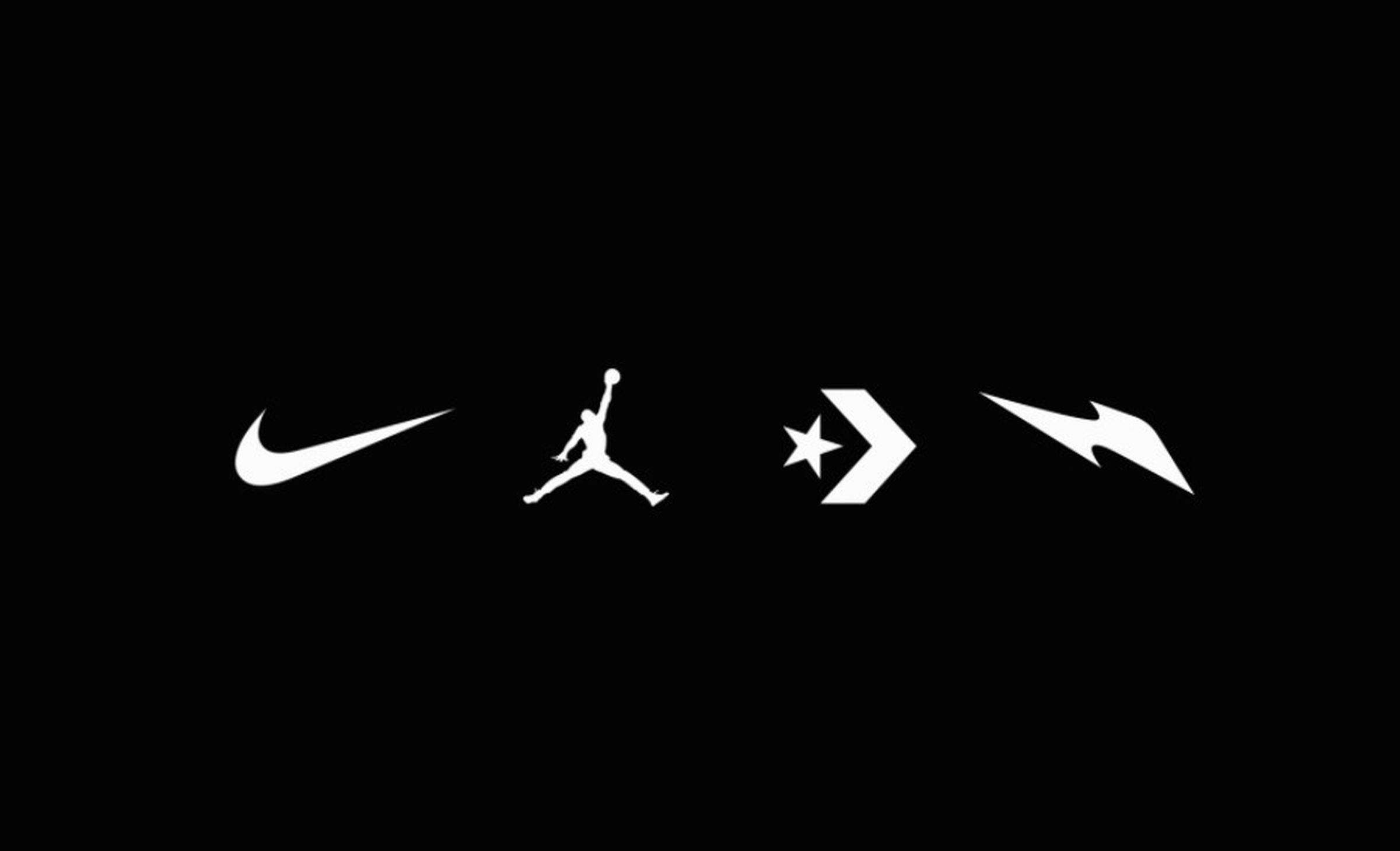 Nike brand logos on a black background, showing the Swoosh, the Jordan Jumpman, the Converse star, and some wacky lightning bolt for the NFT shoe brand RTFKT.