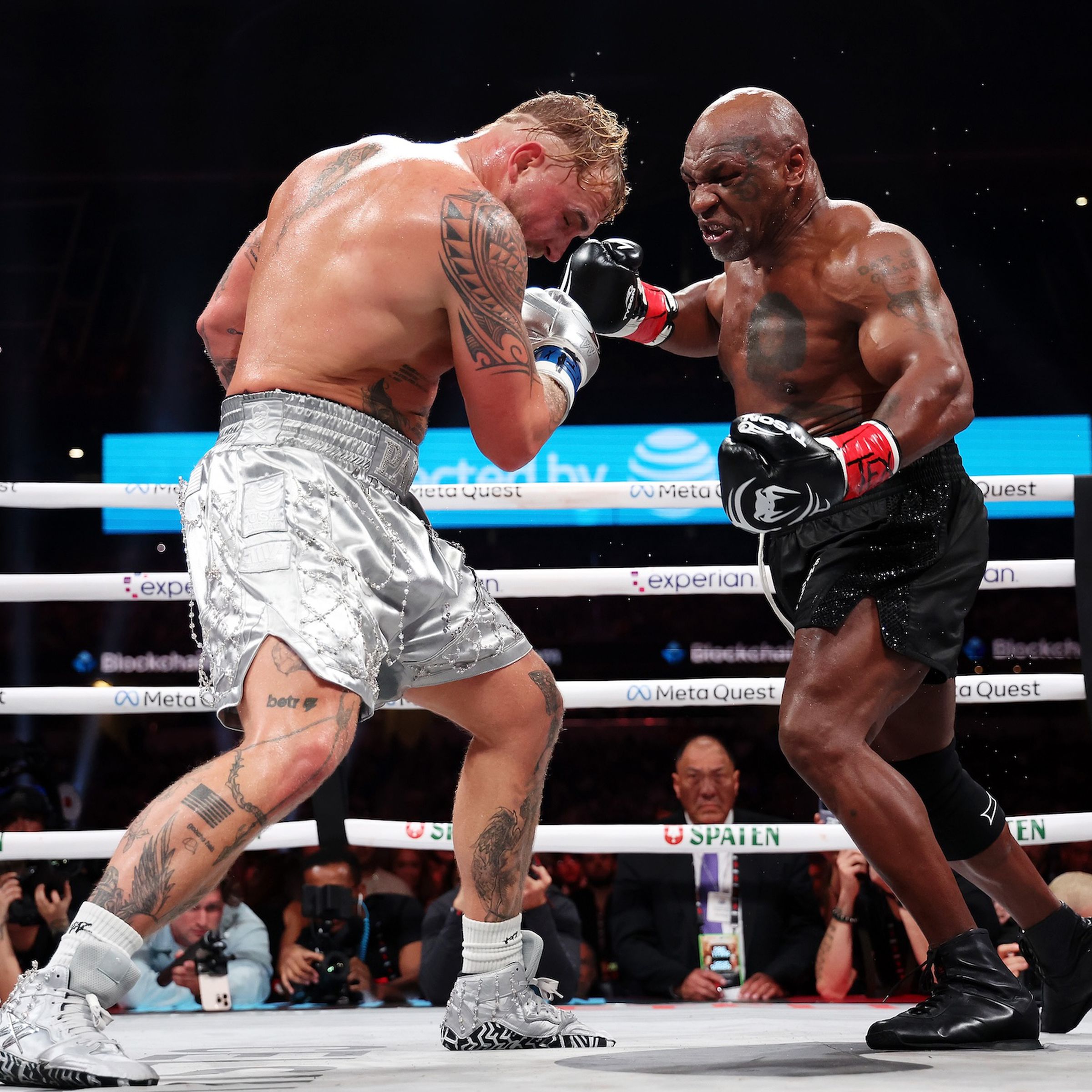 Mike Tyson → and Jake Paul (left), just as Tyson begins to throw a punch.